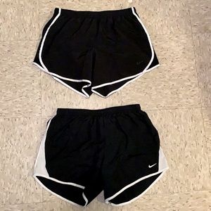 Two pairs of kids Nike shorts.